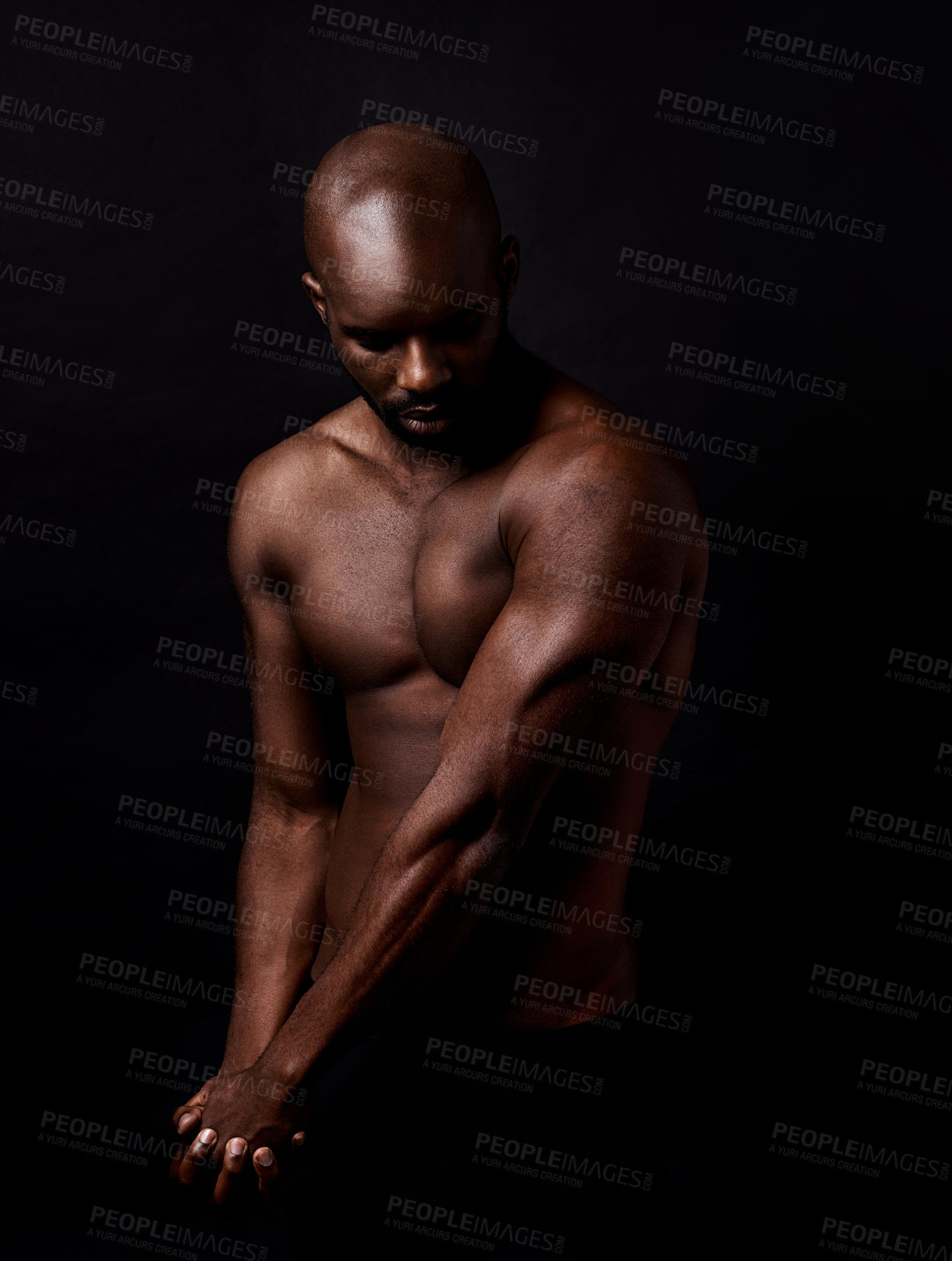 Buy stock photo Black man, muscle and beauty on a dark background for dermatology and shadow or light with art deco or aesthetic. Bodybuilder, model or strong person in studio with arms, workout and fitness results