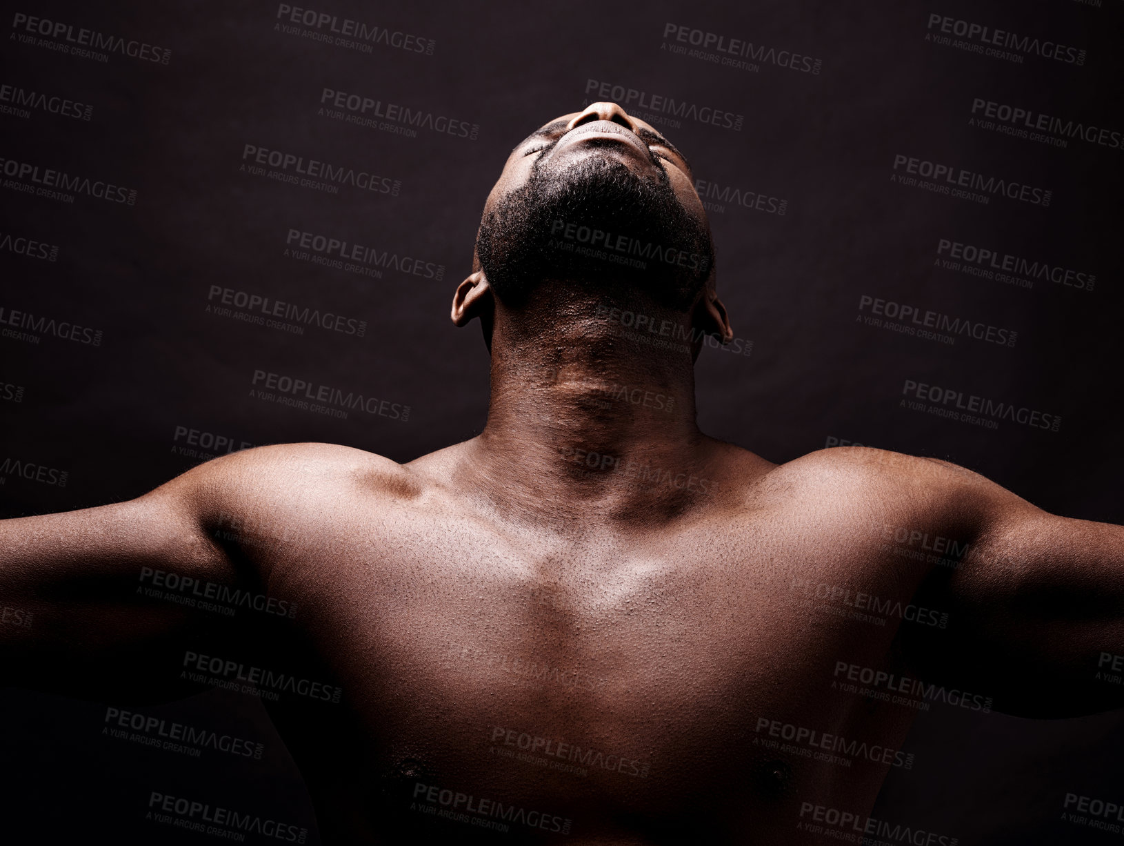 Buy stock photo Looking up, stretching and man on black background with health, wellness and faith or praying in studio. Young person, athlete or African model in art deco with freedom, energy and peace or calm