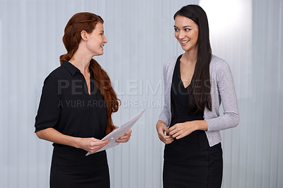 Buy stock photo Shot of two happy business women having a chat at work