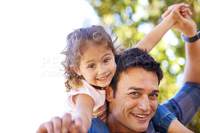 Buy stock photo Shot of a father giving his little girl a piggy back outside