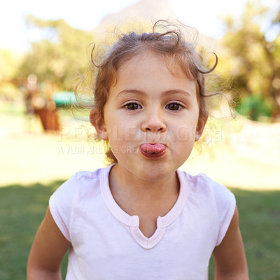 Buy stock photo Portrait of a cheeky little girl sticking out her tongue