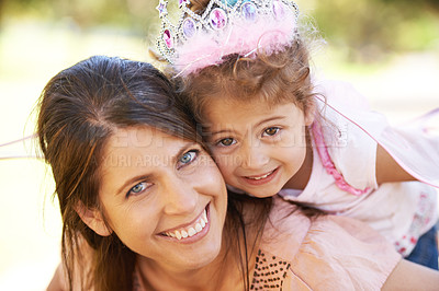 Buy stock photo Cropped shot of a beautiful woman and her daughter playing outdoors
