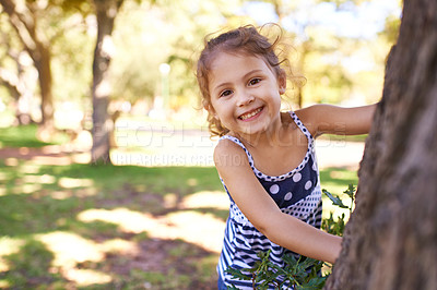 Buy stock photo Young girl, child and portrait in park with games outdoor, playing in nature for childhood and fun with fresh air. Happiness, travel and freedom with youth, public garden or playground with smile