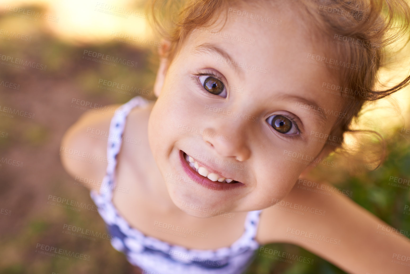 Buy stock photo Girl, child and portrait in park with top view, play games outdoor in nature for childhood and fun with fresh air. Happiness, travel and freedom with youth, public garden or playground with closeup