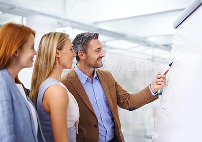 Buy stock photo Teamwork, businessman and writing on whiteboard in presentation for target growth and sales statistics with chart. Graph, mentor and employees with smile in training for financial planning of company