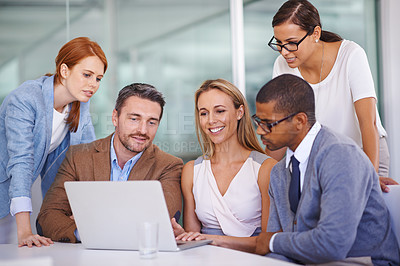 Buy stock photo Shot of a diverse group of businesspeople using a laptop together