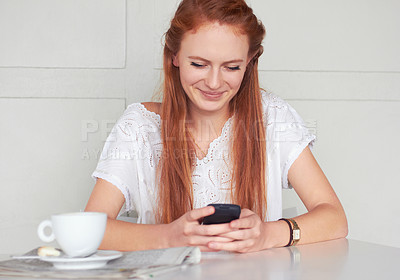 Buy stock photo Coffee shop, phone and happy woman texting, relax and smile for chat app on wall background. Cafe, social media and female customer reading post, news or update while enjoying day off and tea break