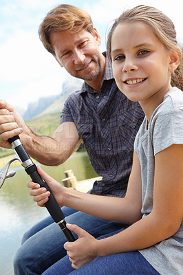 Buy stock photo Father, kid and fishing in nature for teaching, learning and outdoor with holiday, travel or sustainable living in portrait. Happy family, dad or fisherman with girl by water or lake for adventure