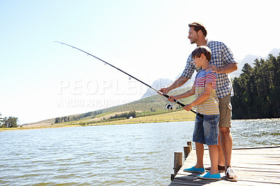 Buy stock photo Shot of a father and son fishing on a dock