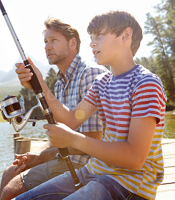 Buy stock photo Shot of a father and son fishing together