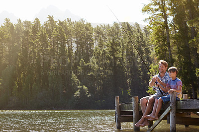 Buy stock photo Shot of a father and son on a fishing trip