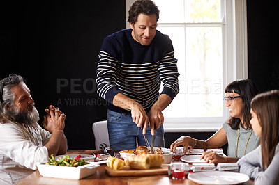 Buy stock photo Family, Christmas and dad carving turkey for festive lunch, bonding and eating together in home. Holiday, celebration and happy people at table with food, drinks and xmas dinner tradition with smile