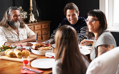 Buy stock photo Shot of a happily family smiling over christmas lunch