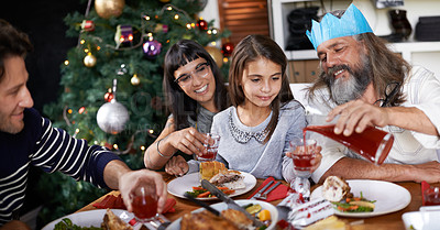 Buy stock photo Christmas, family and parents with child celebrate for dinner, lunch and drinking together for festival. Mother, father and girl with food for holiday, vacation or festive celebration at dining table