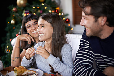 Buy stock photo Christmas, family and happy parents with child in home for dinner, lunch and eating together. Mother, father and girl laughing with food for holiday, vacation and festive celebration at dining table