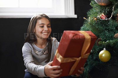 Buy stock photo Girl, child and gift by Christmas tree in home, festive season and present for celebration on xmas. Female person, kid and happy for package on religious holiday, living room and love for tradition