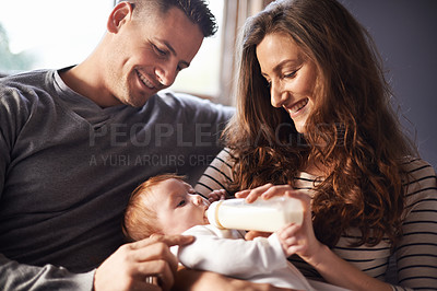 Buy stock photo Mother, father and baby feeding with milk and bottle in a family home with love, support and care. Living room, sofa and relax mom with newborn and drink for youth development and growth in a house
