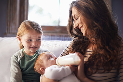 Buy stock photo Mother, baby and milk feeding with child in a family home with love, support and care together. Smile, relax and bottle for youth development and growth with mom and young girl on a living room sofa