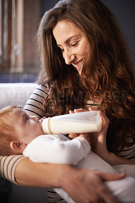 Buy stock photo Mother, baby and milk feeding with bonding in a family home with love, support and care together. Smile, relax and bottle for youth development and growth with mom and happy on a living room sofa