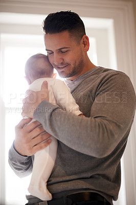 Buy stock photo Father, baby and bonding with hug and love, growth and child development with tender moment at family home. Man, infant or newborn with peace and dad holding kid for comfort, childhood and parenting 