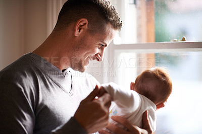 Buy stock photo Father, baby and home with bonding, care and support together with family love at a window. Dad, smile and young child in a house with parent with newborn and man happy and proud about infant 