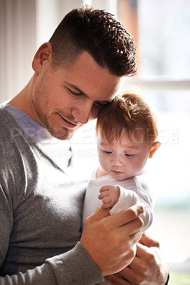 Buy stock photo Shot of a young father holding his adorable baby girl