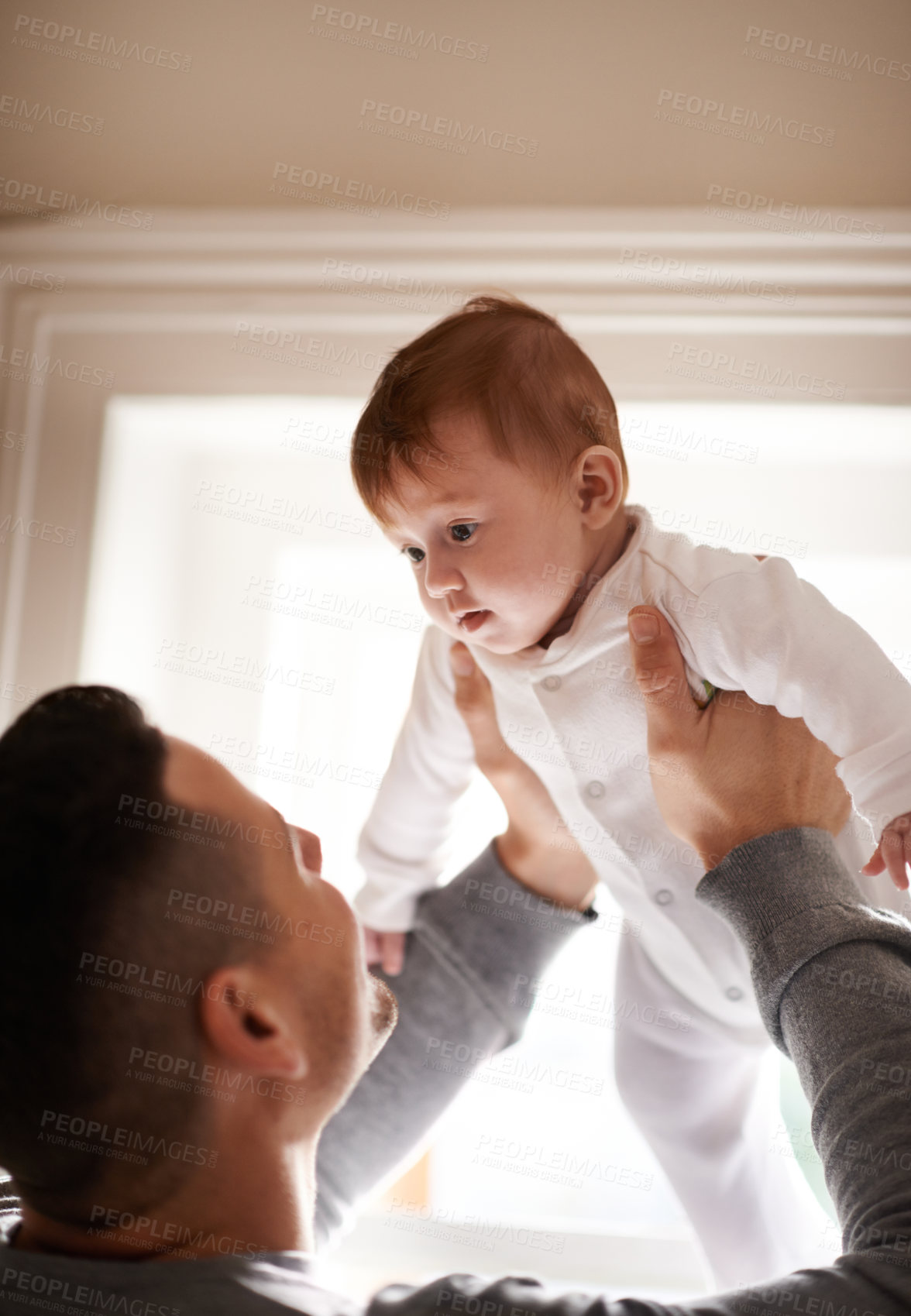 Buy stock photo Love, hug or father lifting baby in a house with care, trust and child development, support or bonding. Family, security and dad with kid at home for learning, safety or morning games with gratitude