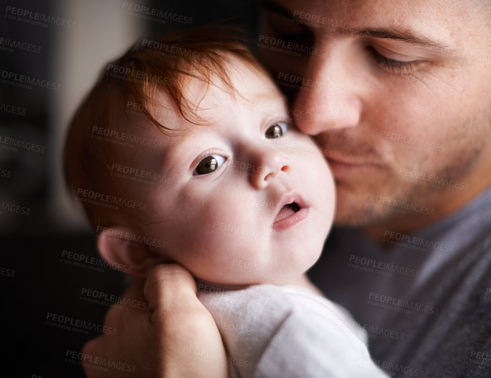 Buy stock photo Closeup shot of an adorable baby girl being held by her father