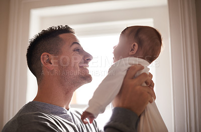 Buy stock photo Father, baby and bonding with smile and love, growth and child development with joy at family home. Man, infant or newborn with happiness and dad holding kid for comfort, childhood and parenting 