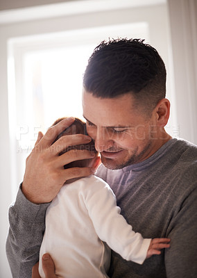 Buy stock photo Dad, baby and pride with hug for bonding, love and happiness with child development and parenting. Peace, calm and childhood with smile, man and newborn infant for tender moment at family home