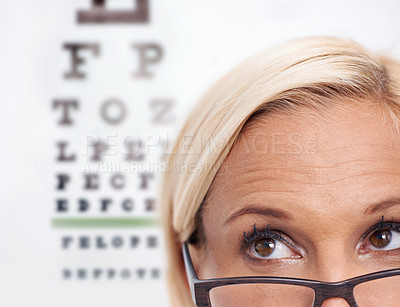 Buy stock photo Woman, glasses and reading of chart for eye test, wellness and frame in closeup. Person or ophthalmologist 
looking up, thinking and ideas for optometry, vision and lens check or exam and assessment