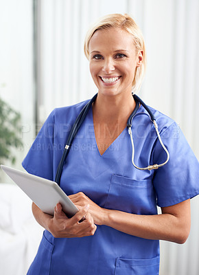 Buy stock photo A shot of a beautiful young doctor at work holding a digital tablet