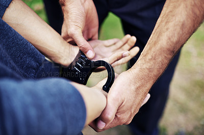 Buy stock photo Police officer, handcuffs and closeup to arrest person for crime with safety, protection or security. People, law enforcement and government service for justice, peace and stop danger in society