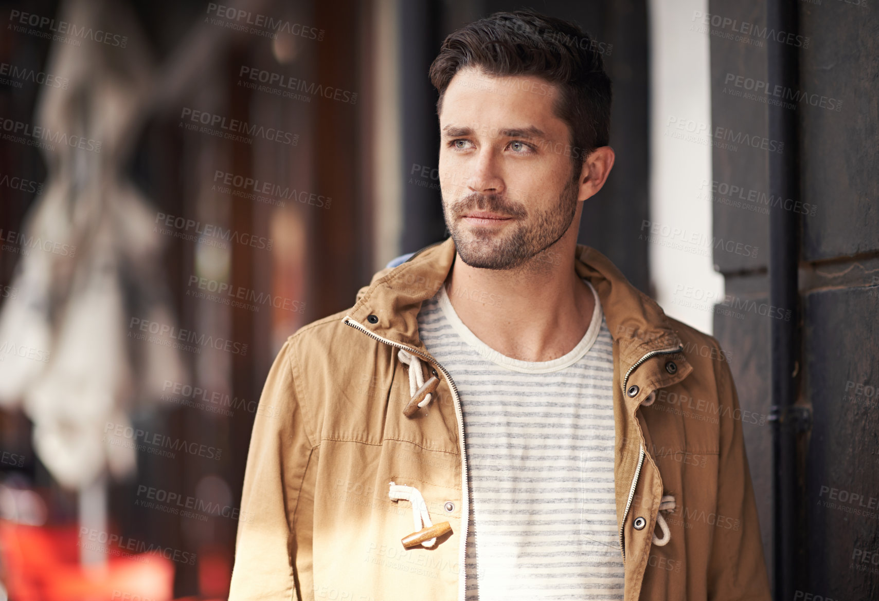 Buy stock photo Cropped shot of a fashionable young man strolling through the city 