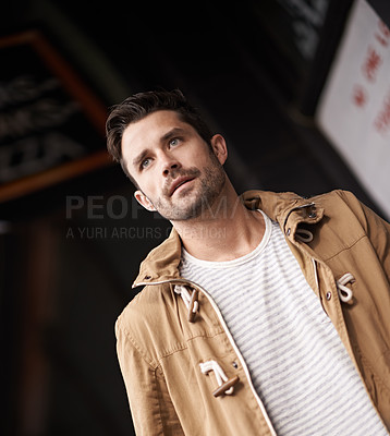 Buy stock photo Man, face and serious in town with fashion on low angle with urban style, trendy outfit and confidence. Male person, walking and outdoor view in town with wellness, casual clothes and morning travel