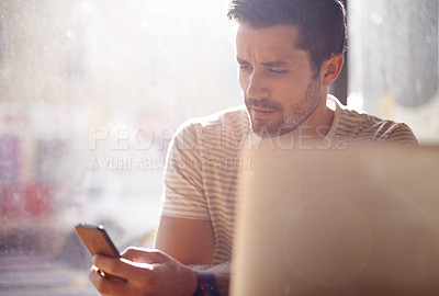 Buy stock photo Man, restaurant and phone or laptop, communication and website for information. Male person, freelancer and app for conversation, social media and remote work in coffee house for internet research