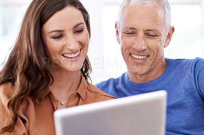 Buy stock photo Couple, tablet and happy in home to relax with reading, search and app to watch movie with bonding. People, woman and mature man on digital touchscreen for notification with web connection in house