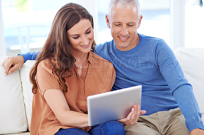 Buy stock photo Couple, tablet and smile on sofa to relax with reading, search and app to watch movie with bonding. People, woman and mature man on digital touchscreen for notification with web connection in house