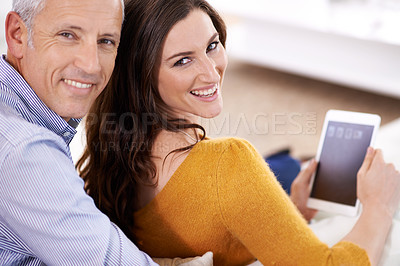 Buy stock photo Couple, portrait and smile with tablet in home with hug for bonding, screen and relax with social media or internet. Senior man, woman or face with digital display for subscription or embrace on sofa