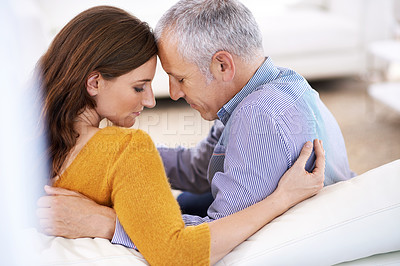 Buy stock photo Rear view shot of a young woman and her mature husband being affectionate