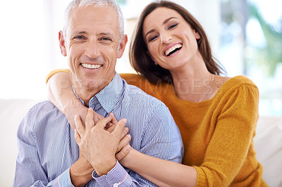Buy stock photo Shot of a mature man being hugged by his younger wife