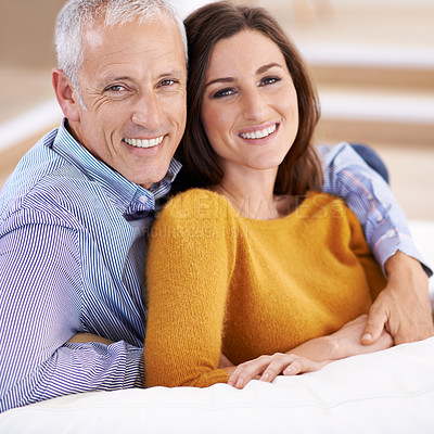 Buy stock photo A happy couple sitting together on their couch