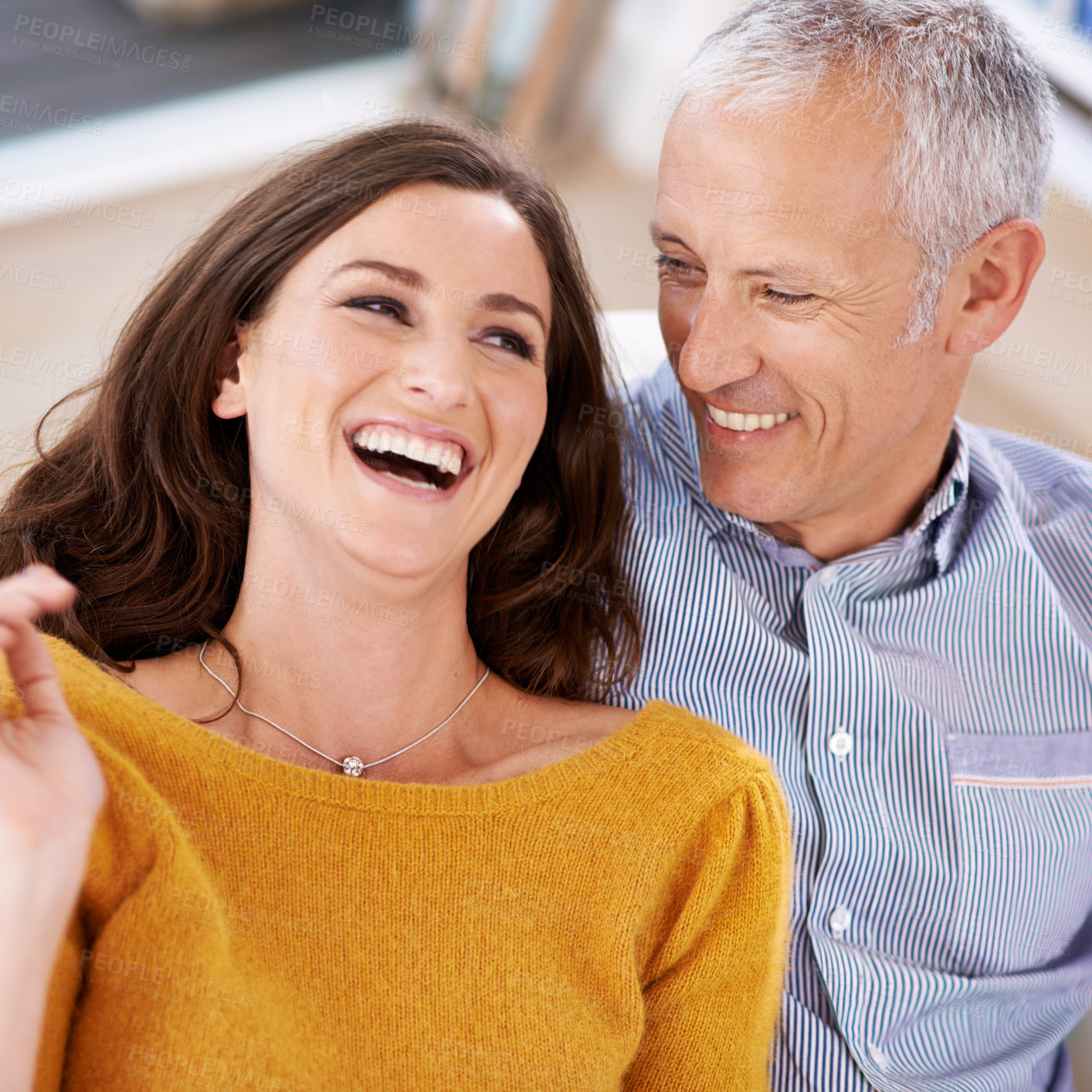 Buy stock photo Couple, happiness and laughing on sofa for love with support, trust and comic joke in living room of house. Senior man, woman and funny in home with embrace, affection and relationship in apartment