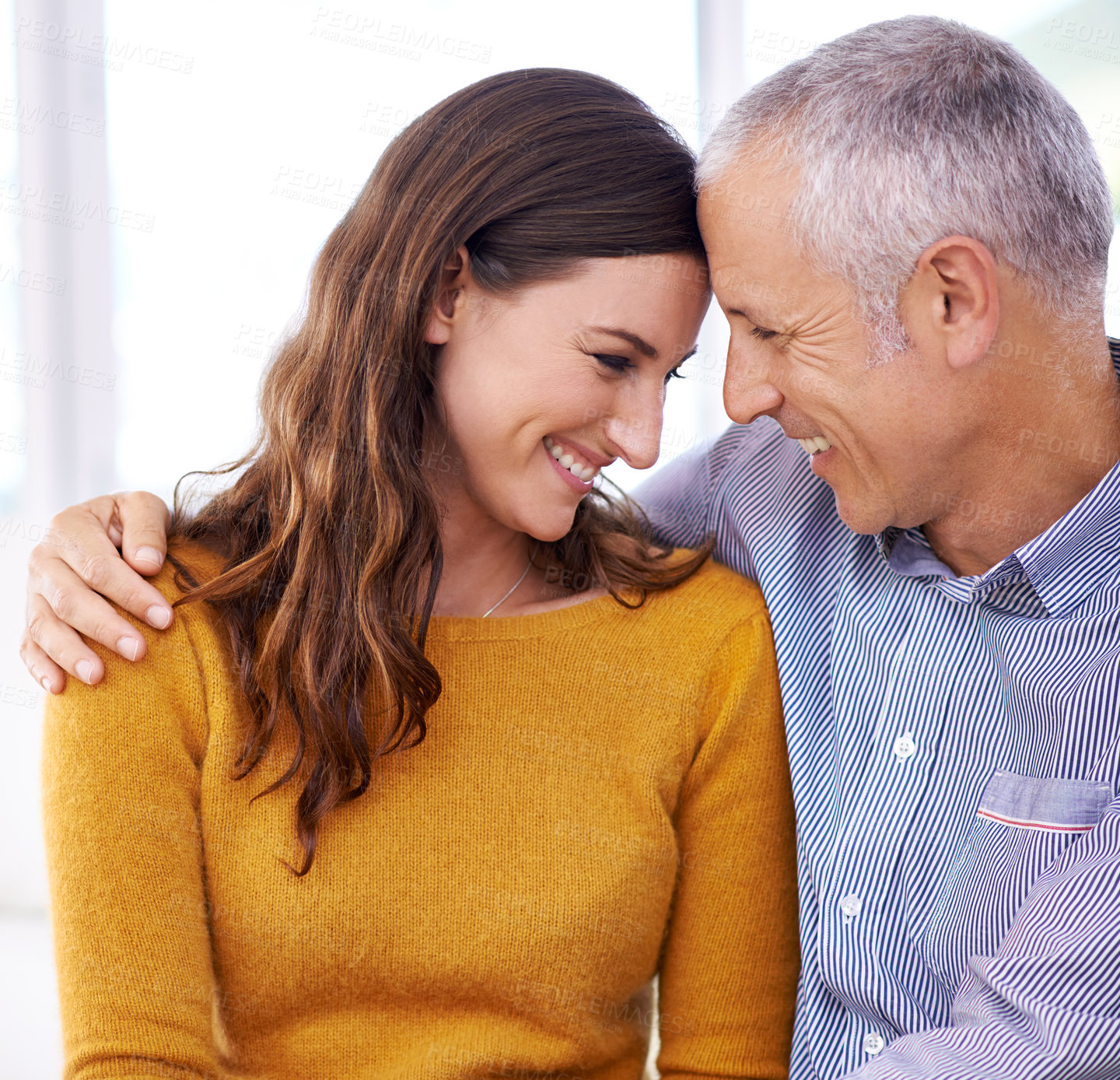 Buy stock photo Couple, laughing and hug in home for love with support, funny joke and comfort in living room of house. Senior man, woman and smile with face for embrace, affection and healthy relationship in lounge