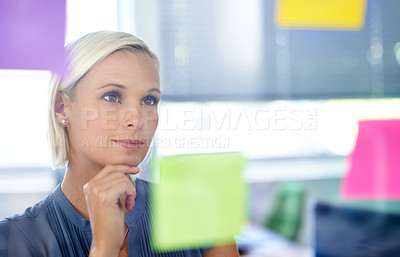 Buy stock photo Woman, glass and wall with thinking, planning and notes with reading, proposal and ideas for development. Person, board and paper with brainstorming process, decision and choice with modern office