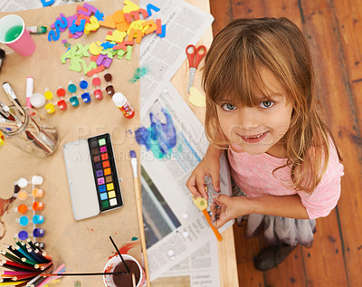 Buy stock photo Happy girl, portrait and drawing with color for creativity, learning or education above. Top view of young child with smile and paintbrush for sketching, writing or artwork in happiness at the house
