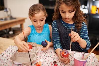Buy stock photo Painting eggs, sisters and home with girls, creative and hobby with recreation and artistic. Youth, siblings and kids with child development and happiness with tools and colour with activity or relax
