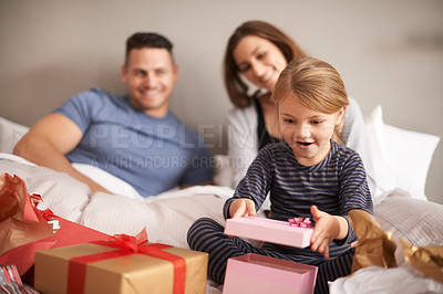 Buy stock photo Parents, child and smile in bedroom with present for gift, surprise and wow in house for birthday. Mother, father and girl with happiness and box with ribbon for receive, family and appreciation