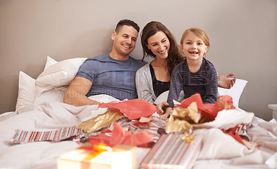 Buy stock photo Love, happy family and gift unboxing in a bed in celebration of birthday, event or mothers day at home together. Support, care and girl with parents in a bedroom with thank you, present or bonding