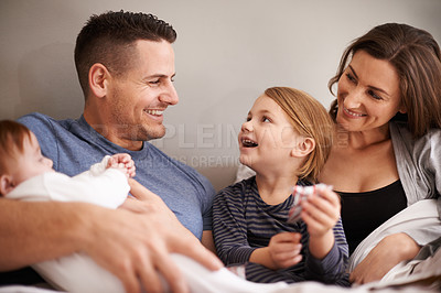 Buy stock photo Shot of an affectionate family in bed